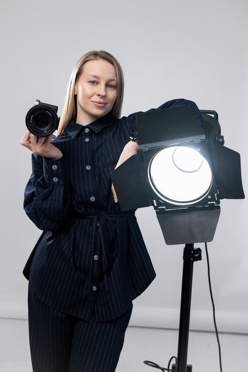 Yevheniia Humanenko in the studio, holding her camera
